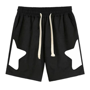 Shorts en coton noir pour homme avec découpes étoiles blanches, taille élastique, design géométrique décontracté, séchage rapide, tissu tricoté respirant - Product Image 1