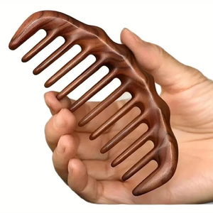Compact light-<b>wood</b> <b>comb</b> with wide teeth presented in a clear protective pouch, available at wholesale prices. - Product Image 4