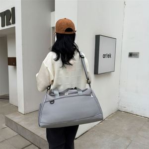Gray Nylon Duffle Bag Rectangular Shape Zipper Closure Shoulder Strap 20-36L Capacity Water Resistant Workout Use - Product Image 1