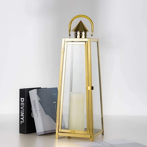 Modern <b>Gold</b> Stainless Steel <b>Lantern</b> with Tapered Design Clear Glass Panels Ideal for Home Decor Indoor Outdoor Use - Product Image 1