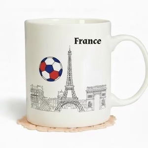 Taza de café/té de cerámica de 11 oz con el horizonte de la ciudad de París, Francia, y un diseño de balón de fútbol en colores azul, blanco y rojo. - Product Image 1