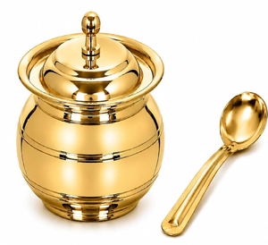 Timeless brass ghee <b>pot</b> accented by an intricate floral border engraving and a matching spoon. Available at wholesale price. - Product Image 6