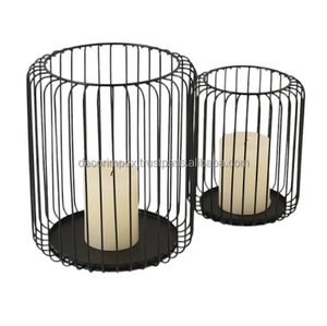 Bougeoirs en métal noir conçus dans un style de cage de fil, chacun tenant un décor de maison de bougie de pilier, et sont également référés - Product Image 1
