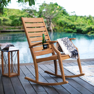 Silla mecedora Cambridge Casual Logan con estructura de madera de teca natural y asiento de listones con acabado de madera natural para uso en exteriores. - Product Image 1