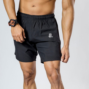 Men's <b>Black</b> Solid Quick Dry Breathable Sport Shorts Elastic Waist Knee Length Nonwoven Polyester Front Logo Drawstring Closure - Product Image 1