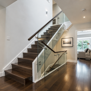 Modern glass stair <b>railing</b> with dark wood handrail for luxury home villa and hotel interiors featuring clear tempered glass pane - Product Image 3