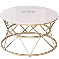 Table basse ronde en aluminium avec base en forme de feuille et plateau en verre transparent, finition dorée