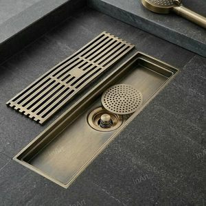 Desagüe de ducha rectangular moderno de bronce cepillado con rejilla extraíble y tapón desplegable - Product Image 1