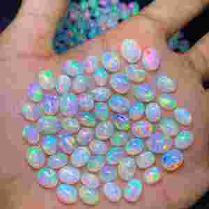 โอปอลเอธิโอเปียธรรมชาติทรงรีเจียระไนขัดเงาหลายสี ขนาด 6x8 มม. น้ำหนัก 1 กะรัต พลอยหลวมสำหรับทำเครื่องประดับ - Product Image 1