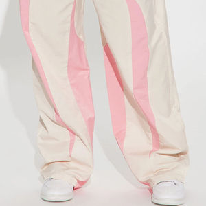 Pantalon parachute blanc ample pour femme avec logo personnalisé, coupe basse, cordon de serrage, coupe-vent en nylon, idéal pour l'hiver - Product Image 4