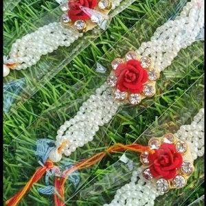 Elegant White Pearl Floral Rakhi Set for Children Handcrafted with a Vibrant <b>Red</b> <b>Rose</b> Centerpiece - Product Image 1