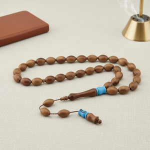Warm amber-<b>toned</b> smooth round tasbih prayer beads attached to an elegant matching <b>red</b> cord, available at wholesale prices. - Product Image 5