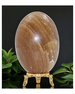 Vente en gros de calcite orange naturelle polie Shiva Lingam avec support en or, ornement en pierre ovale, décoration d'intérieur, objet de collection - Product Image 1