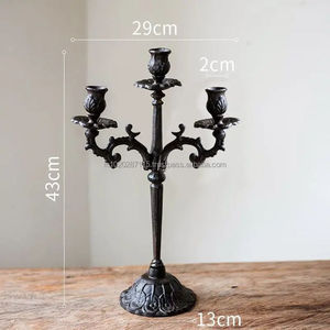 Tall standing <b>black</b> wrought iron <b>candelabra</b> with intricate scrollwork for dramatic lighting in formal dining or living rooms - Product Image 1