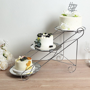 Stunning three-tier silver cake display stand features a stepped ladder design made of twisted wire frames, at wholesale prices. - Product Image 1