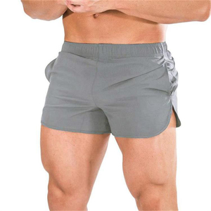 Shorts de sport gris uni coupe-vent à séchage rapide pour homme avec poches, taille élastique, longueur mi-cuisse, en toile de coton - Product Image 1