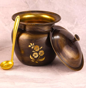 Antique dark finish brass ghee <b>pot</b> with a beautiful floral motif and a golden spoon. Available at wholesale price. - Product Image 1