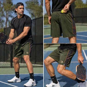 Shorts de pickleball personnalisés vert olive, anti-humidité, en poly-spandex, avec poches zippées et détails orange - Product Image 2
