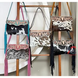 Latest OEM ODM Hand Tooled Genuine Cowhide Leather Fringe Bag Hair On hide Floral & Bull Pattern Designer Piece for Women's - Product Image 1
