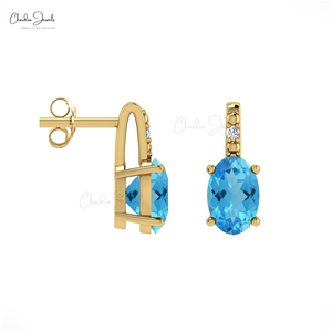 Pendientes de tuerca ovalados de topacio azul suizo de 6x4 mm con detalles de diamantes y cierre a presión de oro macizo de 14k, joyería al por mayor para bodas - Product Image 1