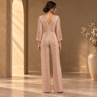 Combinaison de soirée sophistiquée rose poudré ornée de détails, col en V profond |   Combinaison de soirée longue à manches longues, à jambes larges et motifs argentés