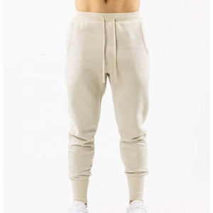 Pantalon de jogging en coton beige pour homme, taille élastique, cordon de serrage, poches latérales, style décontracté streetwear, idéal pour l'automne - Product Image 1
