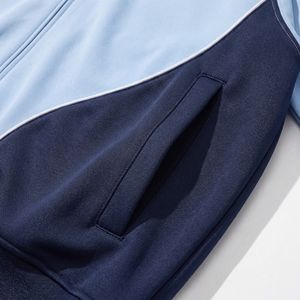 Chaqueta deportiva con paneles en azul marino y azul claro — Ribete blanco, cuello alto con cremallera completa |   Ropa Deportiva Premium OEM / Marca Privada - Product Image 4