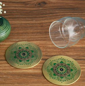 Circular textured brass coaster featuring a central floral stem design and a <b>beaded</b> rim, available at wholesale prices. - Product Image 3
