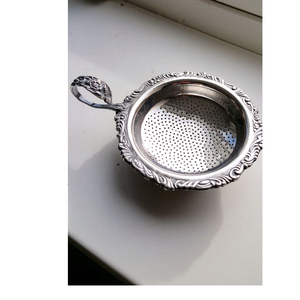 Elegant Silver Tea Strainer with Polished Finish and Bird Handle Design - Product Image 1