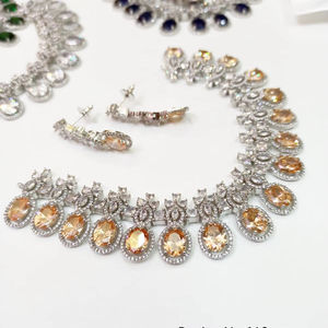 Parure de bijoux de mariage de créateur : Collier en cristal CZ et boucles d'oreilles pendantes en pierre orange pour les soirées - Product Image 1