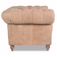Canapé Chesterfield haut de gamme deux places en cuir avec dossier profond matelassé, accoudoirs roulés, structure en bois massif, assise confortable pour salon.