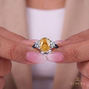 Bague de fiançailles et de mariage personnalisée en or bicolore avec diamant jaune fantaisie de laboratoire taille ovale et trois pierres, et diamant trapézoïdal latéral - Product Image 1