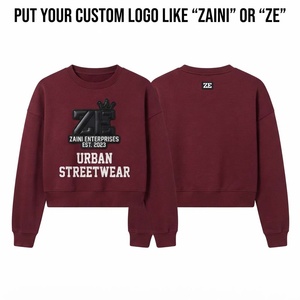 เสื้อครอปท็อปผู้หญิง ผ้าฟลีซคอตตอนพรีเมียม 320 GSM ทรงโอเวอร์ไซส์ ปลายแขนและชายเสื้อแบบริบ  โลโก้ยาง 3 มิติแบบกำหนดเอง สีแดงเบอร์กันดี - Product Image 1