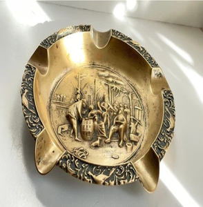 <b>Vintage</b> round brass tavern scene embossed tray <b>ashtray</b> with corner rests, available at wholesale prices. - Product Image 1