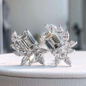 Radiant <b>emerald</b> solitaire <b>stud</b> <b>earrings</b> with marquise diamond accents in floral leaf setting refined luxury jewelry for women - Product Image 2