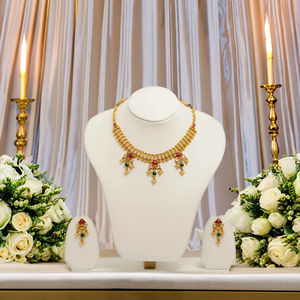 Traditional gold plated choker style necklace set with <b>red</b> green stone <b>drops</b> and matching <b>earrings</b> for bridal wear - Product Image 1