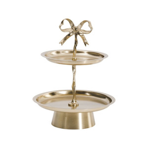 Charming Two <b>Tier</b> Golden <b>Cake</b> Stand Featuring Smooth Circular Trays And A Unique Central Stem Topped With A Bow For Serving - Product Image 1