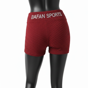 Shorts de tela texturizada roja de poliéster y spandex de 240 GSM premium, suaves y elásticos, con detalle de logotipo con pedrería. - Product Image 2