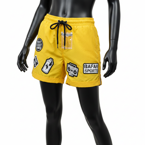 กางเกงขาสั้นวินด์เบรกเกอร์สำหรับผู้หญิง ผ้าไนลอนพรีเมียม สีเหลืองล้วน สไตล์สตรีท พร้อมโลโก้ปะยาง ป้าย PVC - Product Image 1