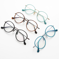 Monture de lunettes en titane légère et ronde en gros avec plaquettes nasales réglables pour les acheteurs de détail d'optique