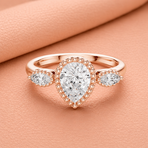 Bague de fiançailles de luxe en or rose avec halo de moissanite taille poire et pierres latérales marquise pour femme - Product Image 1