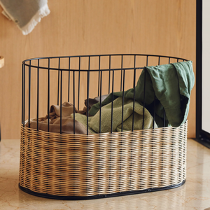 Oval <b>laundry</b> <b>basket</b> featuring a black wire frame upper section and a fine-woven <b>wicker</b> bottom base, available at wholesale price - Product Image 1