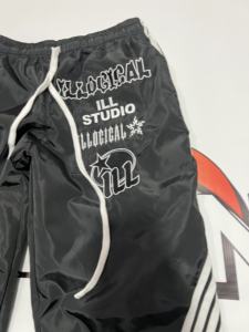 กางเกงวอร์มพิมพ์ลายทรงโอเวอร์ไซส์คุณภาพสูงสำหรับผู้ชาย กางเกงกันลมสะท้อนแสง ตกแต่งด้วยการปักลายไนลอน - Product Image 2