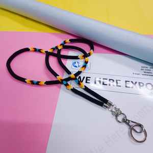 Chaîne de corps perlée faite à la main et colorée, portée par une femme en chemise blanche et avec une carte d'identité, mettant en valeur l'artisanat vibrant des artisans. - Product Image 3