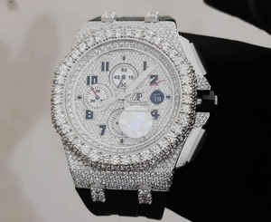 Montre chronographe de luxe incrustée de diamants avec lunette étincelante et bracelet noir, avec chronométrage précis et design audacieux - Product Image 1