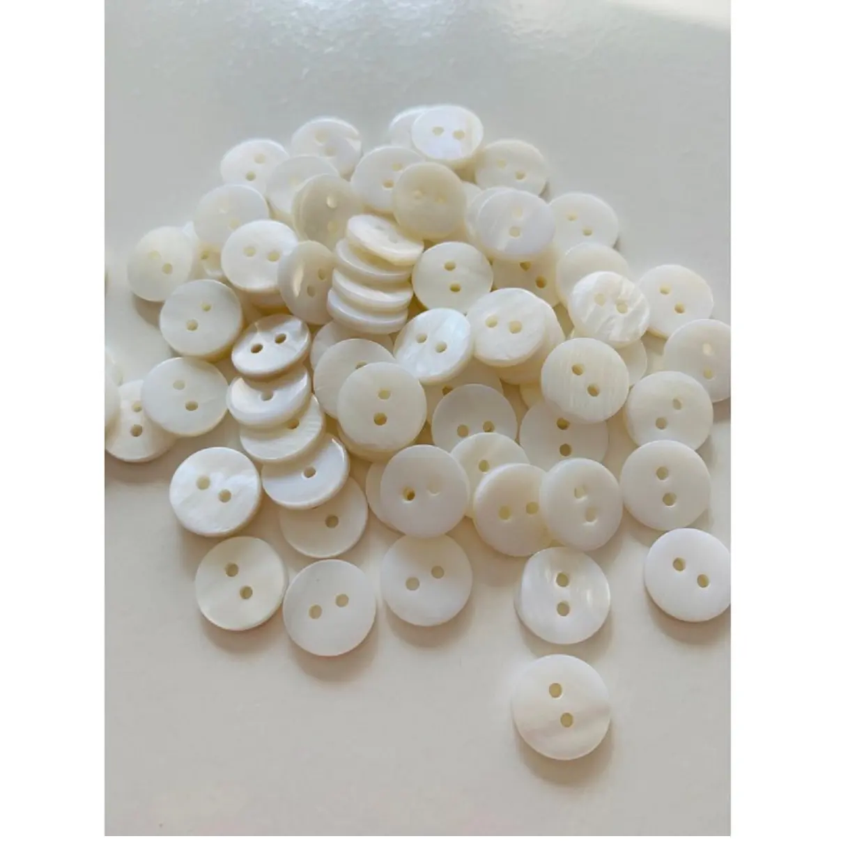 mother of pearl shell shirt buttons made in assorted sizes for clothing manufacturers and jewelry designers