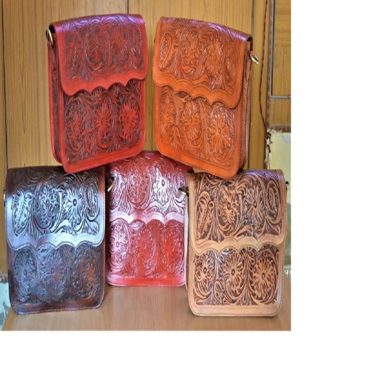 custom made multi coloured hand carved leather wallets, purses and bags made from real leather with intricately carved patterns