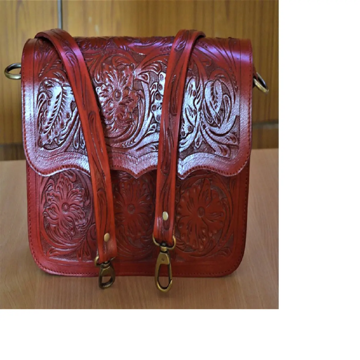 custom made maroon coloured hand carved leather wallets, purses and bags made from real leather with intricately carved patterns