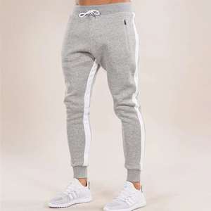 M & F Pantalones de chándal informales de algodón para hombre con bolsillos con cremallera Raya lateral Cintura media Frente plano Método de tejido no tejido teñido liso - Product Image 3