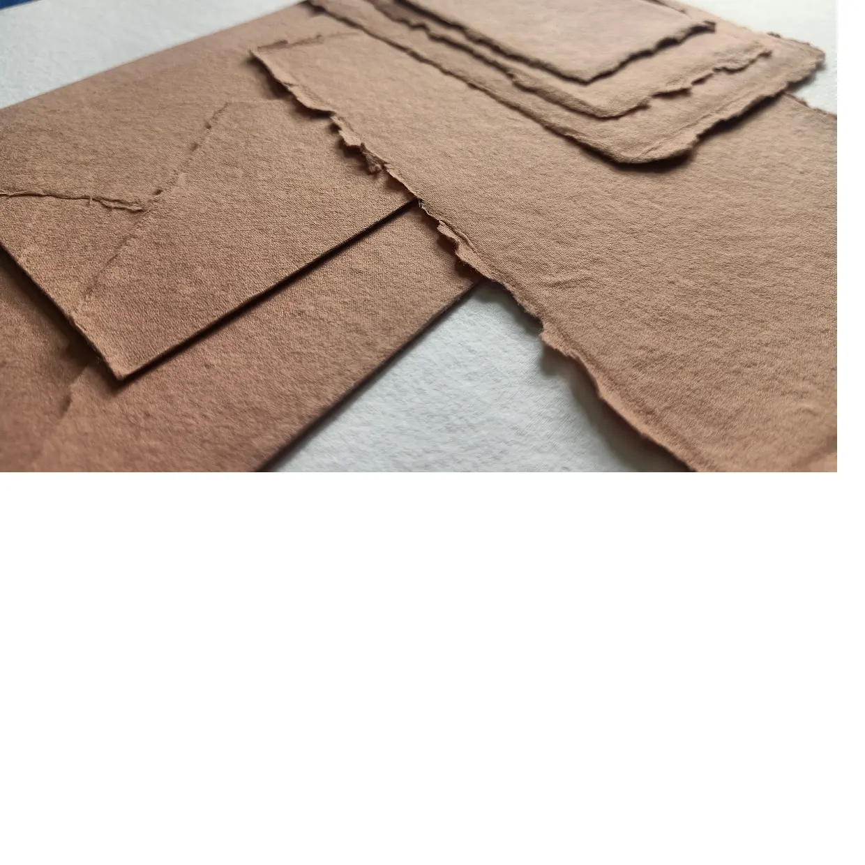 custom made deckle edged paper and envelopes in sand color suitable for use by wedding stationers and invitation designers